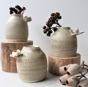 These calming designs were inspired by a camping trip in the Australian bush.  Each piece is one of a kind made on the potter’s wheel allowing the different clays to mix together and create unique, marbled patterns.   The bud vases are a practical size for holding a small bunch of flowers or natural stems.  They come with the addition of a resting bird sculpture on a solitary flower.  