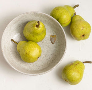 A slightly deeper bowl, 20 X 6 that has been wheel thrown and carved by hand. This bowl is ideal as a fruit bowl or for salad.  The gold leaf detail and carved outer make it a one of a kind vessel.   As these details are a precious metal, 23K gold, they are not microwave safe.