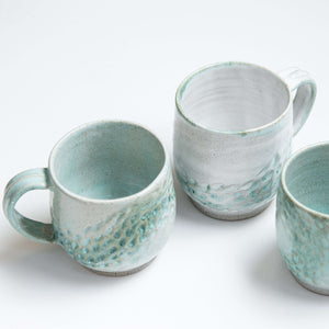 These ocean-inspired mugs celebrate the textures of the sand and turquoise tones of the ocean, taking you there if only for a few moments.  They are wheel thrown and high fired for strength and durability.  They are hand carved with multiple layers of glazes making each one unique.