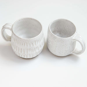 These wheel thrown and carved mugs have the perfect combination of comfort and texture. They are light and durable, making them appealing and user friendly.  